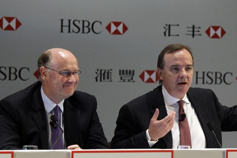 Mr Flint (far left), HSBC Holdings chairman, and Mr Gulliver, the bank's CEO, have announced 87,000 job cuts, exited over 80 businesses and cut the bank's global presence to 71 countries and territories since 2011. The bank has not commented on the S