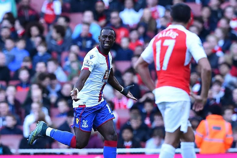 Crystal Palace's Yannick Bolasie celebrates after scoring against Arsenal during their league match at the Emirates. Arsene Wenger has admitted that the EPL title is beyond his reach after the 1-1 draw.