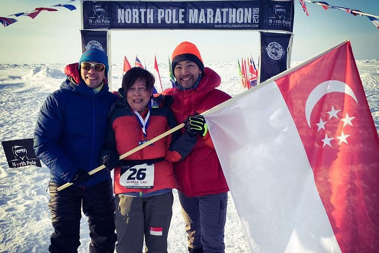 (From left) Mr Ong Yu-Phing, Ms Gloria Lau and Mr Ong Tze Boon at the finish line of the North Pole Marathon on Sunday. The start of the race had been delayed for about a week after cracks formed on the ice sheet in the Arctic Ocean.