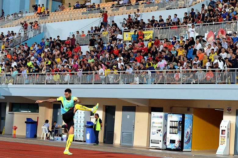 A section of the estimated 2,900 fans at the 3-3 draw between Tampines Rovers and Geylang International at Jurong West Stadium on Feb 15 watch as star attraction Jermaine Pennant warms up.