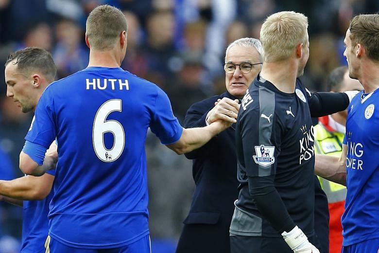 Leicester City manager Claudio Ranieri congratulates his German centre-back Robert Huth after his side's resounding 4-0 victory over Swansea. The Foxes need five points from their remaining three games to fight off second-placed Tottenham's challenge