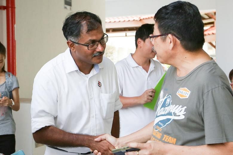 Mr Murali Pillai visiting residents at Block 114, Bukit Batok West Avenue 6, during his walkabout. He has pledged to put his constituents first, saying his late father had taught him to "always put community before self".