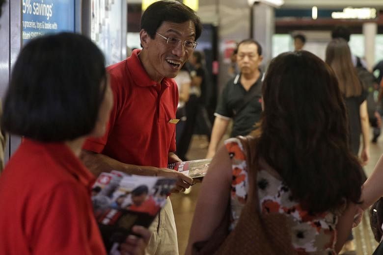 SDP chief Chee Soon Juan giving out fliers at Bukit Batok MRT Station yesterday. He said the party will spell out how it plans to ensure a smooth takeover of the town council should he win the Bukit Batok by-election.