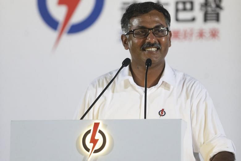 (Below) Mr Murali greeting people attending the PAP rally at Bukit Gombak Stadium last night. As the PAP's candidate for the single seat, he said he will have the support of the party's Jurong GRC MPs if he is elected. Mr Murali speaking at his first