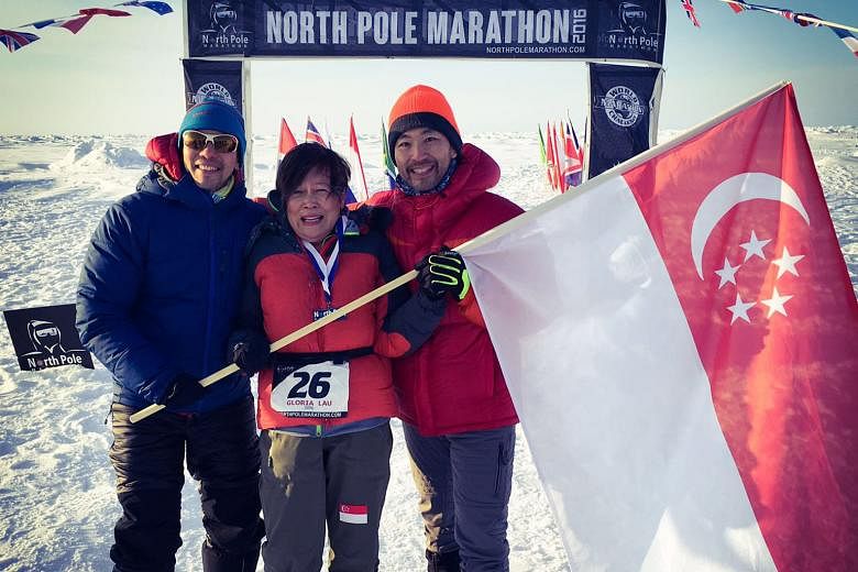 Mr Ong Yu-Phing (left), Ms Gloria Lau and Mr Ong Tze Boon at the finish line of the North Pole Marathon on April 17. All three Singaporeans took part for charity. Ms Lau, who at 64 was the oldest of the 11 female runners in the race, is the first Sin