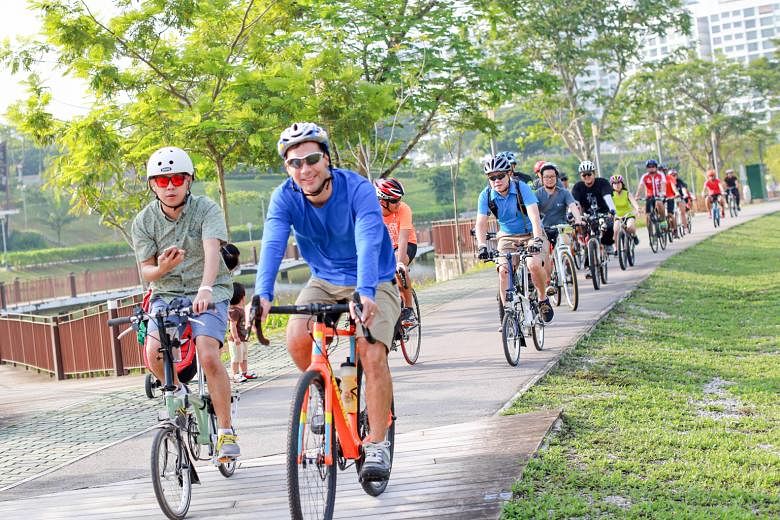 Participants of the OCBC Cafe Bike Crawl cycling along a 18km route at Punggol with numerous stops to eat and rest along the way. The bike crawl is one of the fringe activities ahead of the OCBC cycle in October.