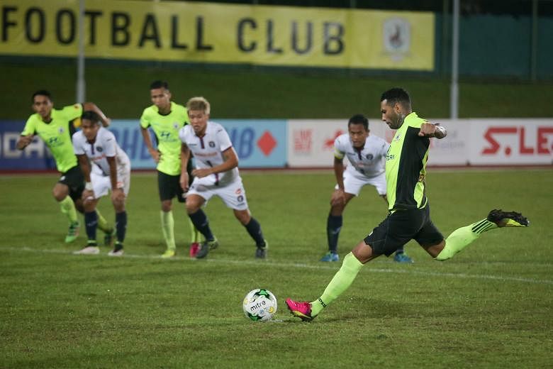 Tampines' Jermaine Pennant scoring his team's second goal from the penalty spot. The Stags defeated 10-man Warriors FC 4-2 at the Jurong West Stadium yesterday.