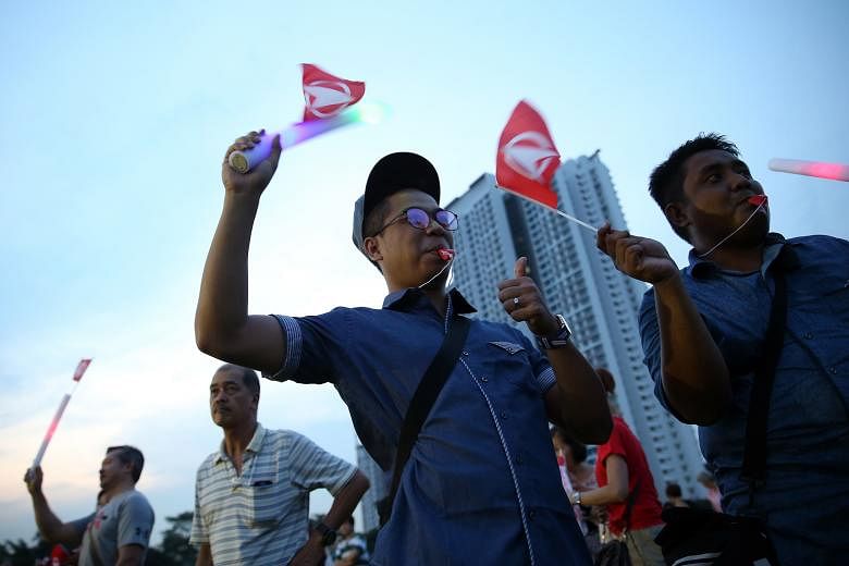SDP supporters attending a campaign rally at a field in Bukit Batok Industrial Park A last Friday. Party candidate Chee Soon Juan is making his fifth attempt to enter Parliament.