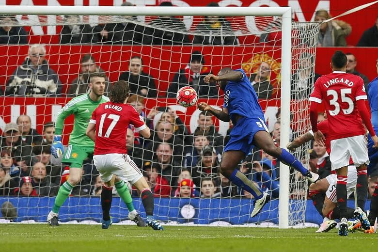 Leicester City's captain Wes Morgan (in blue) heading past Manchester United goalkeeper David de Gea for the equaliser. The match ended 1-1, which means the Foxes have only lost three of their 36 league games this season.