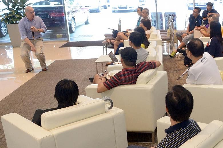 Dr Michael Soon (top left) sharing causes and treatments of common sports injuries with participants at the ST Run clinic at the Land Rover showroom in Leng Kee Road. Some 50 people attended.