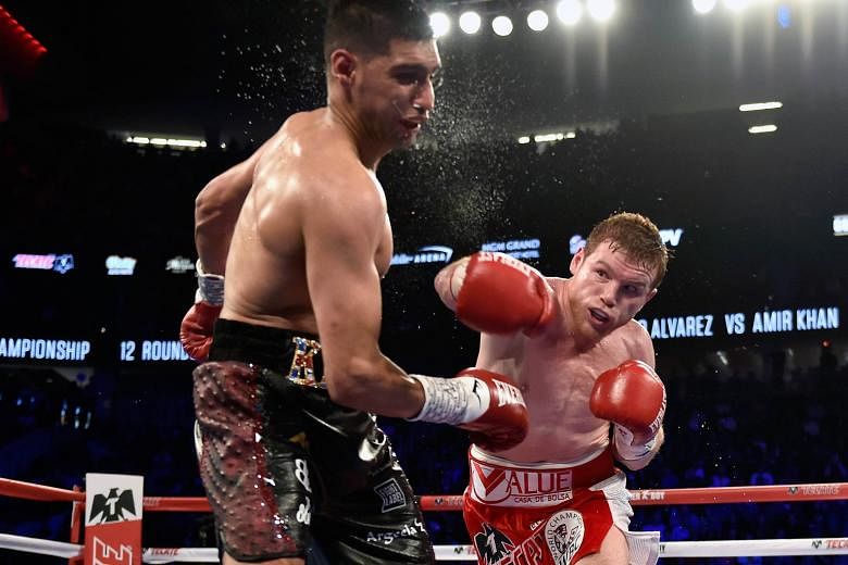 British boxer Amir Khan (left) is knocked out by Saul "Canelo" Alvarez of Mexico during their WBC middleweight title fight in Las Vegas on Saturday.