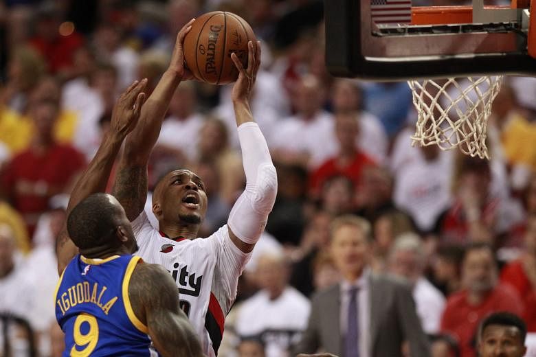 Portland Trail Blazers guard Damian Lillard taking a close-range shot against Golden State Warriors forward Andre Iguodala at the Moda Centre. But it was from beyond the arc that Lillard did the most damage, with his eight threes making up 24 of his 