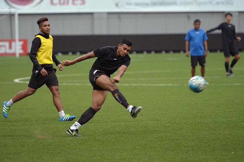 Tampines Rovers striker Fazrul Nawaz attempting a shot as midfielder Izzdin Shafiq looks on during training at the Jalan Besar Stadium yesterday. Coach V. Sundramoorthy does not feel that nerves will be a problem.