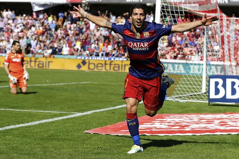Luis Suarez celebrating the second of his three goals at Granada that helped Barcelona clinch the Spanish title on the final day of the season. The Primera Liga top scorer's 38th, 39th and 40th goals of the season for a 3-0 win meant that Cristiano R