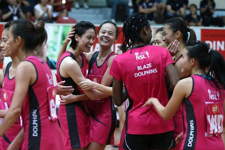 Cassandra Soh (left) celebrates with Micky Lin, after scoring the winning goal to help the Blaze Dolphins defeat the Sneakers Stingrays 50-49 yesterday.