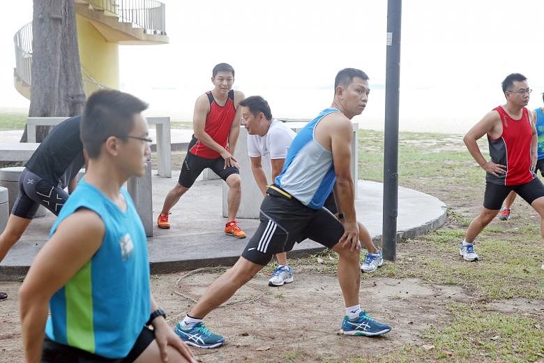 Minister for Social and Family Development Tan Chuan-Jin stretching during a run with grassroots volunteers at East Coast Park. Mr Tan will be participating in The Straits Times Run in the City next Sunday.