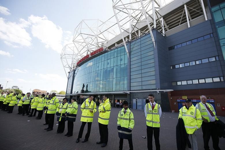 Stewards standing outside Old Trafford after the incident on Sunday. The final league game of the season between Manchester United and Bournemouth will be played today.