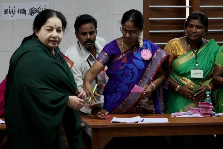 Ms J. Jayalalithaa (left), Chief Minister of the southern Indian state of Tamil Nadu and party leader of the All India Anna Dravida Munnetra Kazhagam (AIADMK), arriving to cast her vote at a polling station in Chennai yesterday in state assembly elec