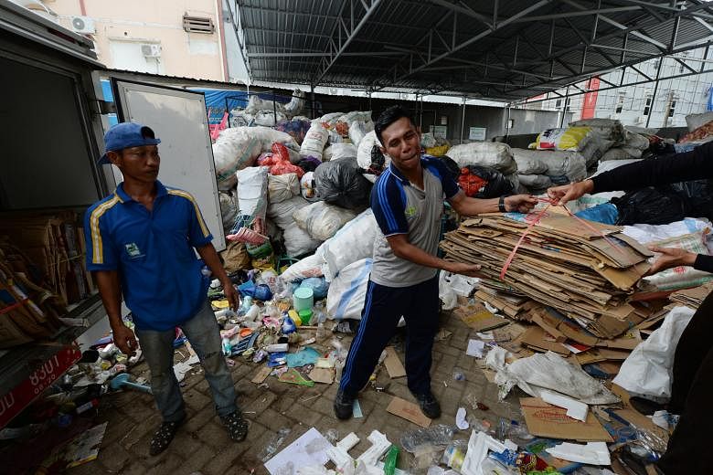 A bundle of cardboard being taken to the Mutiara Trash Bank in Makassar on Sulawesi island on March 11. Residents take recyclable trash to collection points, where it is weighed and given a monetary value.