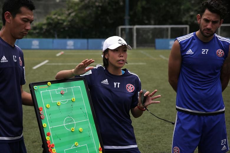 Hong Kong trailblazer Chan Yuen Ting, during training with assistant coach Lai Kai Cheuk and Australian forward Andrew Barisic, is the first female coach to take a men's football team to a top-flight title.