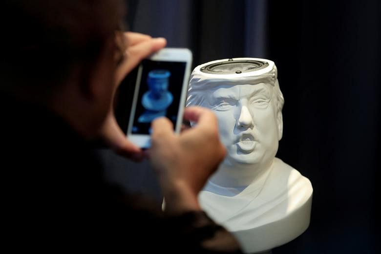 A man taking a picture of a Sound Of Power speaker in the shape of a bust of Mr Trump. Ms Brewer Lane is disputing the New York Times' account of her meeting with the presumptive Republican presidential nominee in 1990.