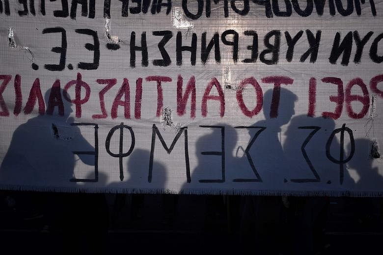 Protesters in Athens on May 8 at a rally against the latest reform measures demanded by Greece's creditors. IMF's debt- restructuring proposal goes much further than plans advanced by euro-zone creditors locked in talks to trigger Greece's next aid p