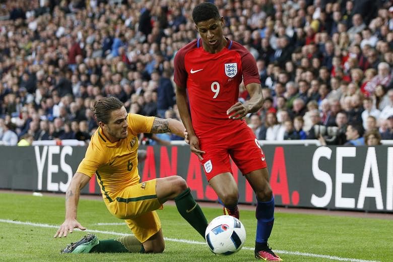 England's Marcus Rashford eluding the challenge of Australia's Joshua Risdon during the 2-1 friendly win on Friday. Besides scoring on his England debut, Rashford also pleased manager Roy Hodgson with a lively performance on the flanks when Wayne Roo