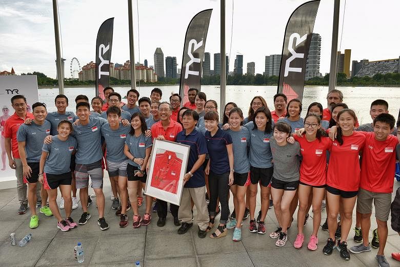 Singapore Swimming Association president Lee Kok Choy (centre of front row, in red) together with the national swimming athletes, after sealing a record sponsorship deal with apparel maker TYR. The partnership will see its athletes across four discip