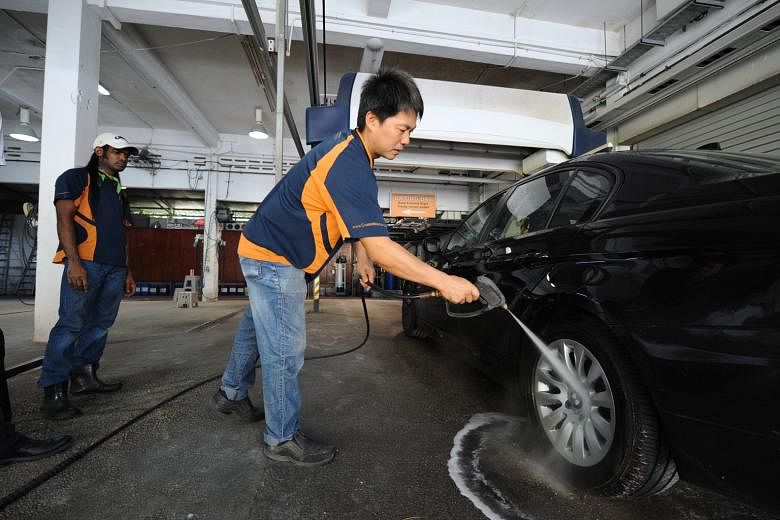 Mr Tan, managing director of car grooming firm Groomwerkz, showing how his company uses de-ionised water to wash cars. Home-grown water treatment firm De.Mem has been treating water to make it de-ionised for Groomwerkz's car wash services, making car