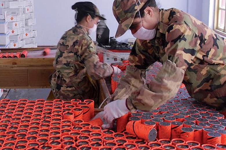 Fabchem China workers assembling explosives, a mainstay product of the company.