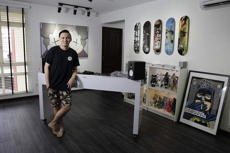 The black-and-white palette in the living room (above) of the five-room HDB flat in Sengkang extends into the bedroom (below). The white DJ console in the living room of Mr Christopher Kurt Loy (above) has been custom-made to hide its cables.