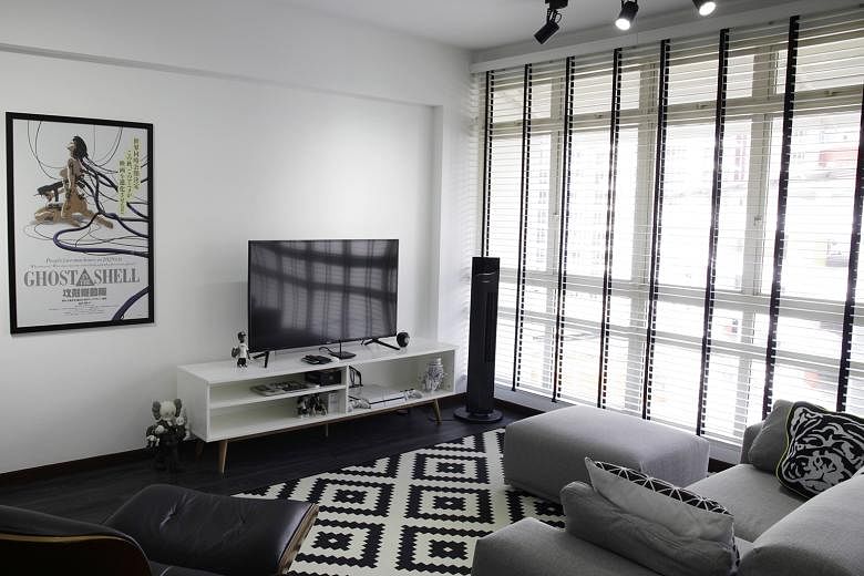 The black-and-white palette in the living room (above) of the five-room HDB flat in Sengkang extends into the bedroom (below). The white DJ console in the living room of Mr Christopher Kurt Loy (above) has been custom-made to hide its cables.