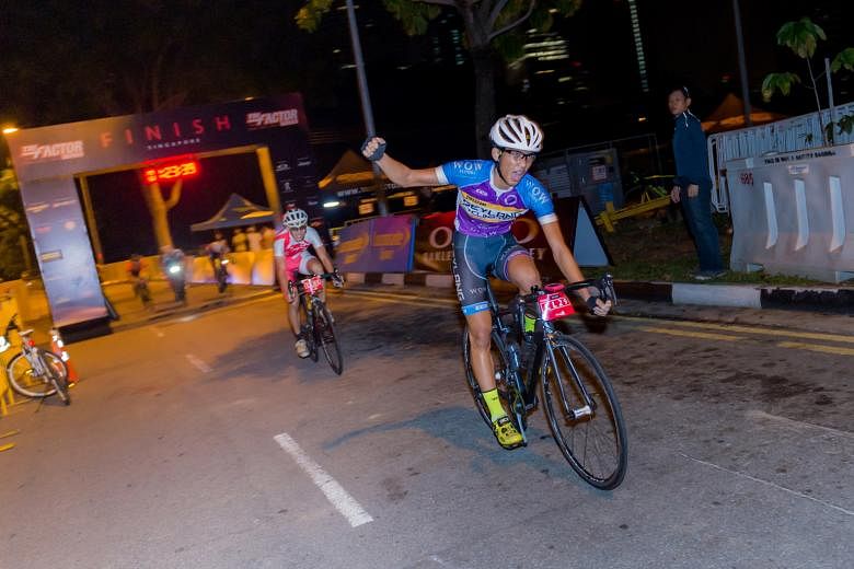 Waving a triumphant right fist, Muhammad Ghazzi Krisna crosses the finish line in first place, as he topped the 56km club challenge at the TRI-Factor Bike 2016 yesterday. His time of 1hr 23min 39sec beat Merrill Chua (behind) by a second. The mass cy
