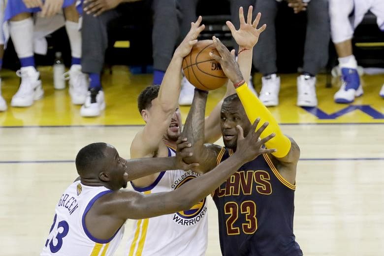 Cleveland forward LeBron James struggles to shrug off the attentions of Golden State's Klay Thompson and Draymond Green during the Cavaliers' 110-77 Game 2 defeat by the Warriors. Green notched a game-high 28 points as the Warriors opened up a 2-0 se
