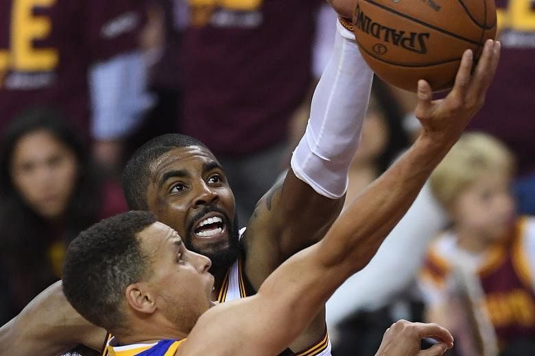 Golden State's Stephen Curry going up for a basket, as Cleveland's Kyrie Irving desperately tries to block him. For the first time in the NBA Finals series, the Warriors point guard had a solid game, with 38 points in the 108-97 win as Klay Thompson 