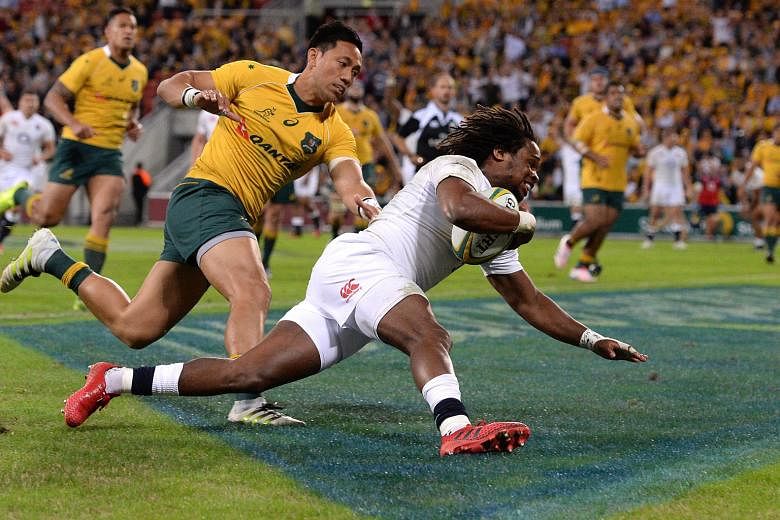 Marland Yarde of England (right) scores a try during the first Test against Australia yesterday. Head coach Eddie Jones had earlier spoken of Yarde as having the potential to become a "really special player" and the winger played a pivotal role in th