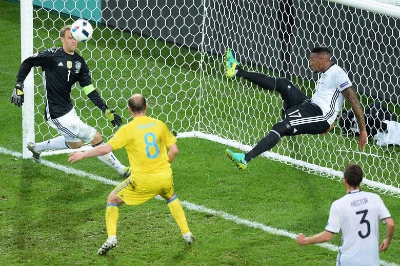 Germany defender Jerome Boateng's goal-line clearance prevents Ukraine from equalising, with goalkeeper Manuel Neuer well beaten, during their Group C game.