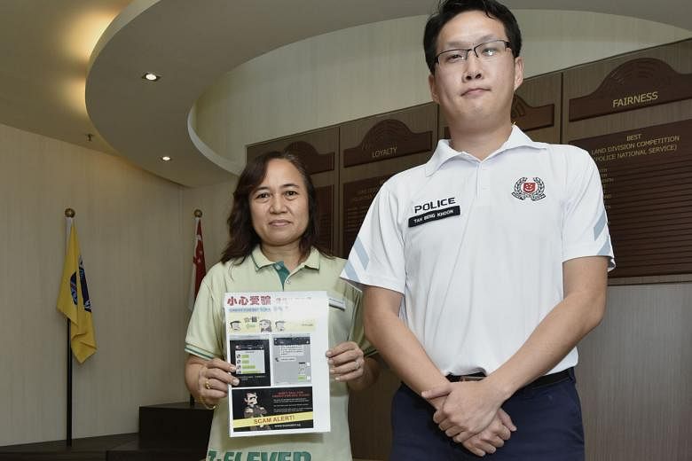 Store manager Rosida Arshad of a 7-Eleven outlet in Yishun with the scam advisory alert to help prevent customers from falling prey to the credit-for-sex scam. With her is community policing unit officer Tan Beng Khoon from Yishun North neighbourhood