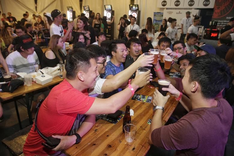 Guests making a toast at the electronic marquee at the Beerfest Asia event last Saturday.