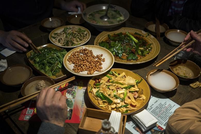 A table full of traditional Sichuan dishes at Tian Yuan Yinxiang in Chengdu. Old-timers want to preserve the cuisine's culinary heritage.