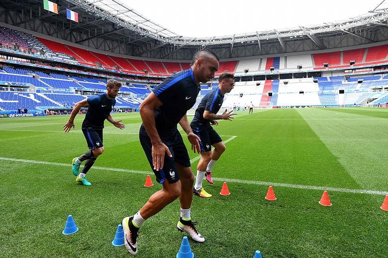 France forwards Dimitri Payet (front) and Antoine Griezmann training in Lyon's Parc Olympique Stadium ahead of their clash against Ireland. The duo are likely to provide support up front for Olivier Giroud.