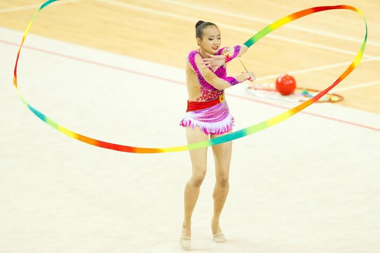 National gymnast Tong Kah Mun, 18, twirling her colourful ribbon while performing her routine at the Singapore Open Gymnastics Championships at Bishan Sports Hall. After finishing second in the ribbon competition yesterday, the all-around runner-up a