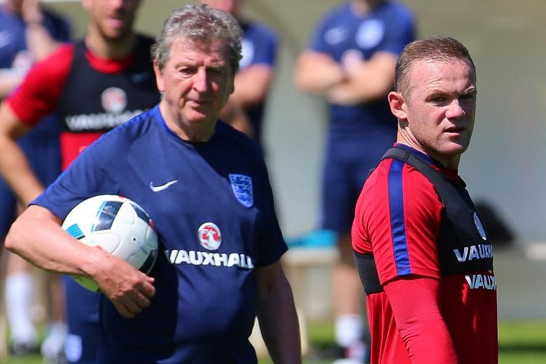 Roy Hodgson and Wayne Rooney at a training session last week. While the manager has "no regrets" about dropping Rooney against Slovakia, a loss to Iceland would end his time at the helm.