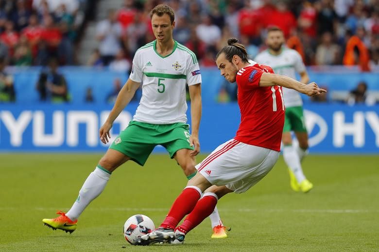 Northern Ireland defender Jonny Evans (left) keeping a watchful eye on Wales' Gareth Bale. Evans had his opponent in his pocket for most of the game, matching him for craft and graft until the decisive cross leading to the goal.