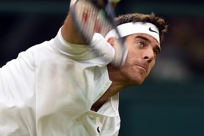 Juan Martin del Potro of Argentina serving against Stan Wawrinka of Switzerland at Wimbledon yesterday. Del Potro, the 2009 US Open champion, came back from the loss of the opening set to win 3-6, 6-3, 7-6 (7-2), 6-3 in the second round.