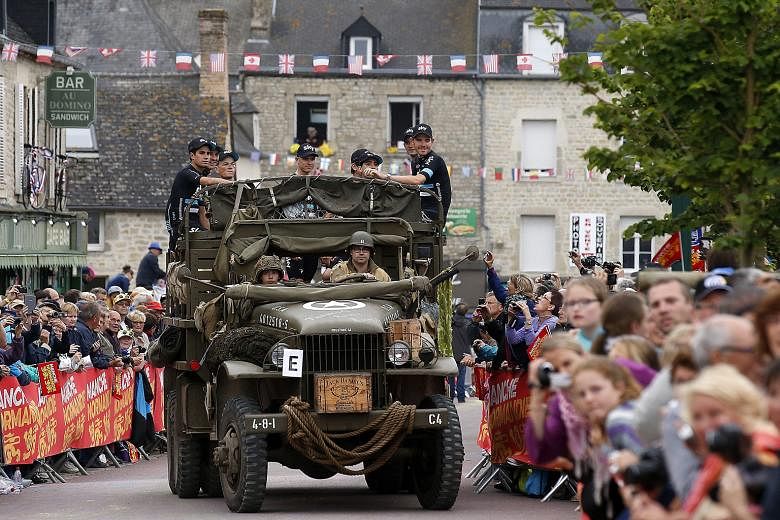 Team Sky rider Chris Froome (centre) and his team-mates arriving in a vintage military truck for the team's presentation ahead of the 103rd Tour de France, which starts in Mont Saint-Michel today.