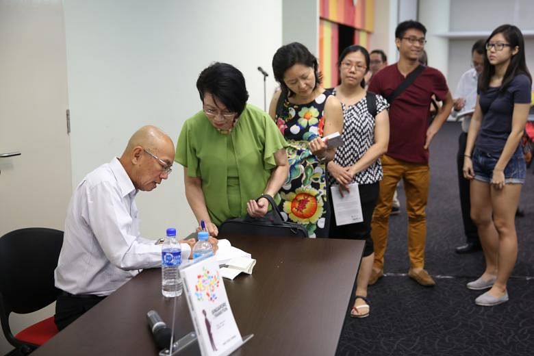 Former Straits Times editor Han Fook Kwang signing his book for readers at The Big Read Meet.