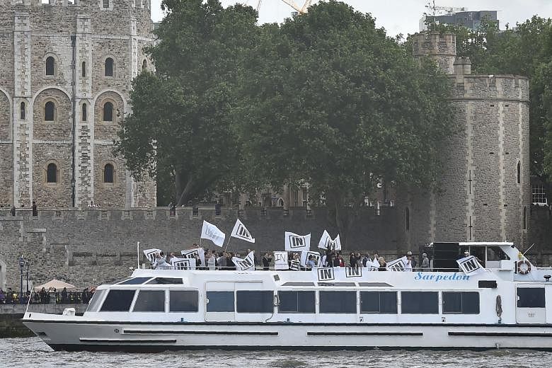Stay: A boat carrying supporters of the IN campaign to remain in the EU sailing past the Tower of London on the River Thames on June 15. Leave: A boat decorated with flags and banners from a group campaigning for a "leave" vote in the EU referendum s