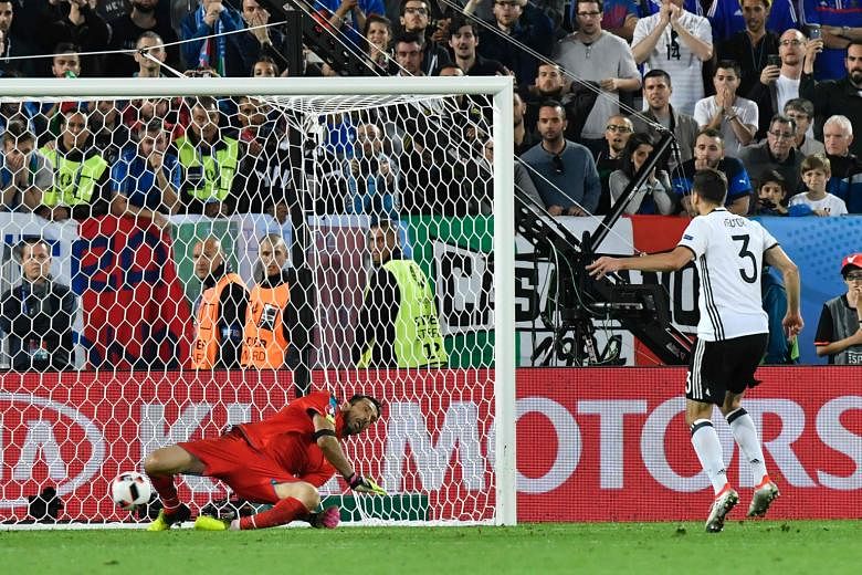 Germany defender Jonas Hector's spot kick squirms beneath diving Italy goalkeeper Gianluigi Buffon, giving Germany a 6-5 shootout win to advance to the semi-finals.