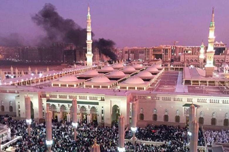 Smoke rising after a bombing near the Prophet's Mosque in Medina, Saudi Arabia, on Monday. Singapore's Ministry of Foreign Affairs has condemned strongly the attacks in three places in Saudi Arabia.